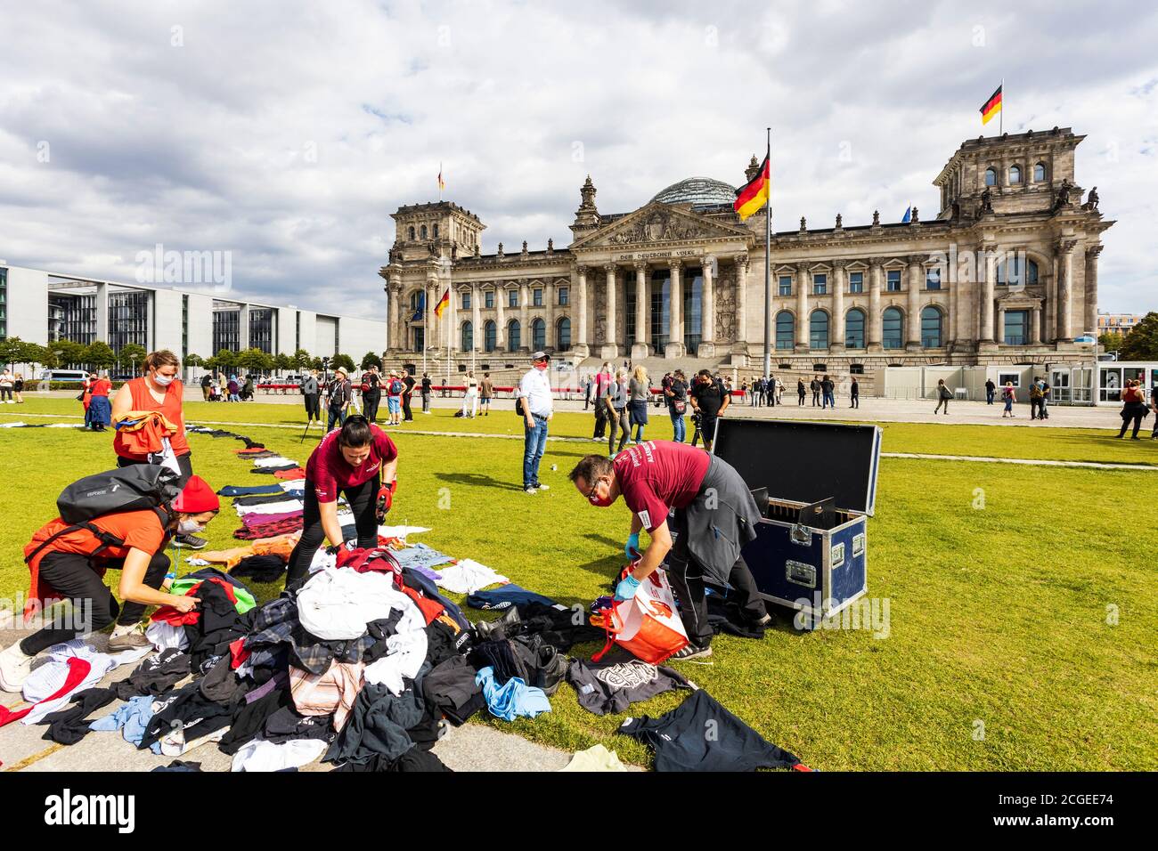 Berlin, Germany. 9 September 2020. Red Alert Protest of people affected by the closure of cultural organisations and events due to the Coronavirus crisis. People donating t-shirts from an event for a vigil in front of the Reichstag building. Stock Photo
