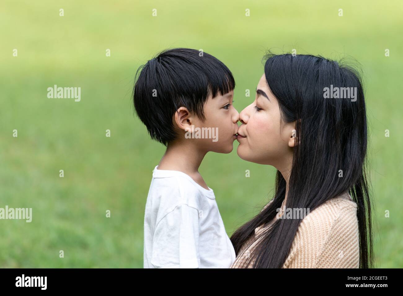 Portrait beautiful Asian mom and her cute son kissing with love while  looking at each other, cute and warm Stock Photo - Alamy