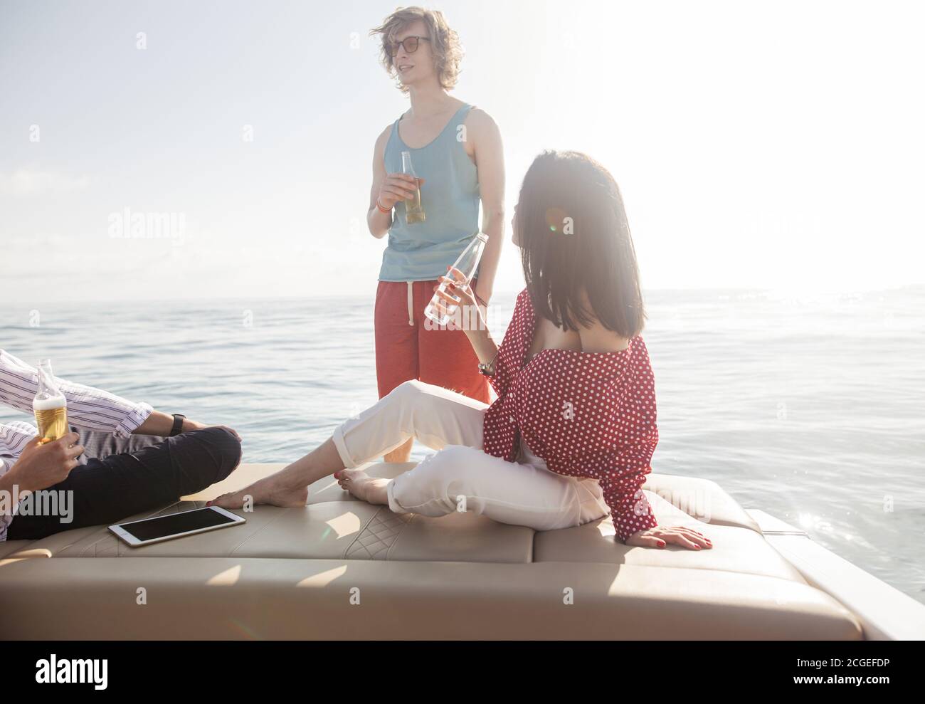 friends drinking beers in boat party. Group of people partying on yacht