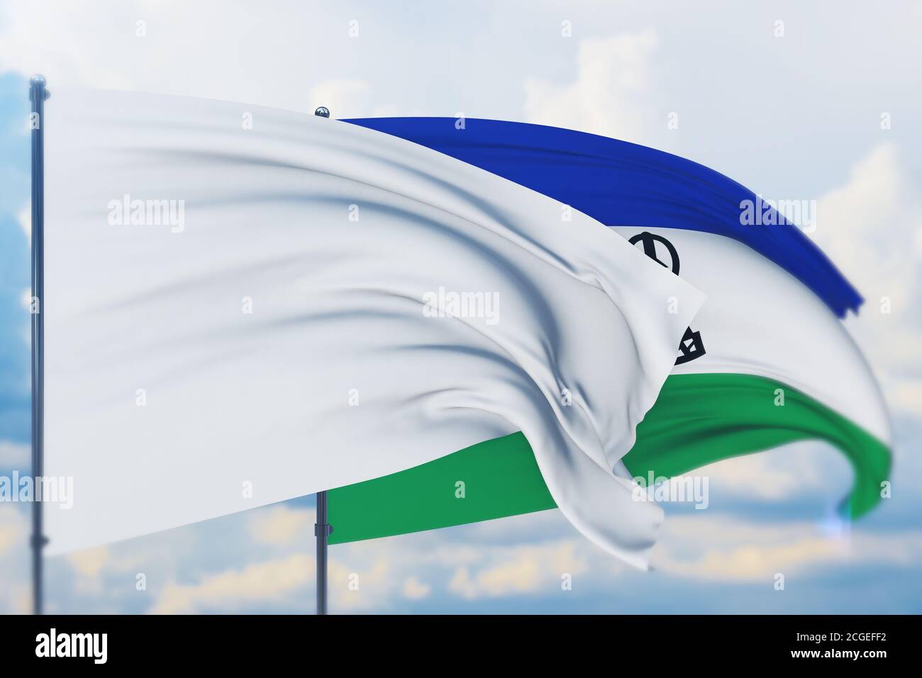 White flag on flagpole waving in the wind and flag of Lesotho. Closeup ...