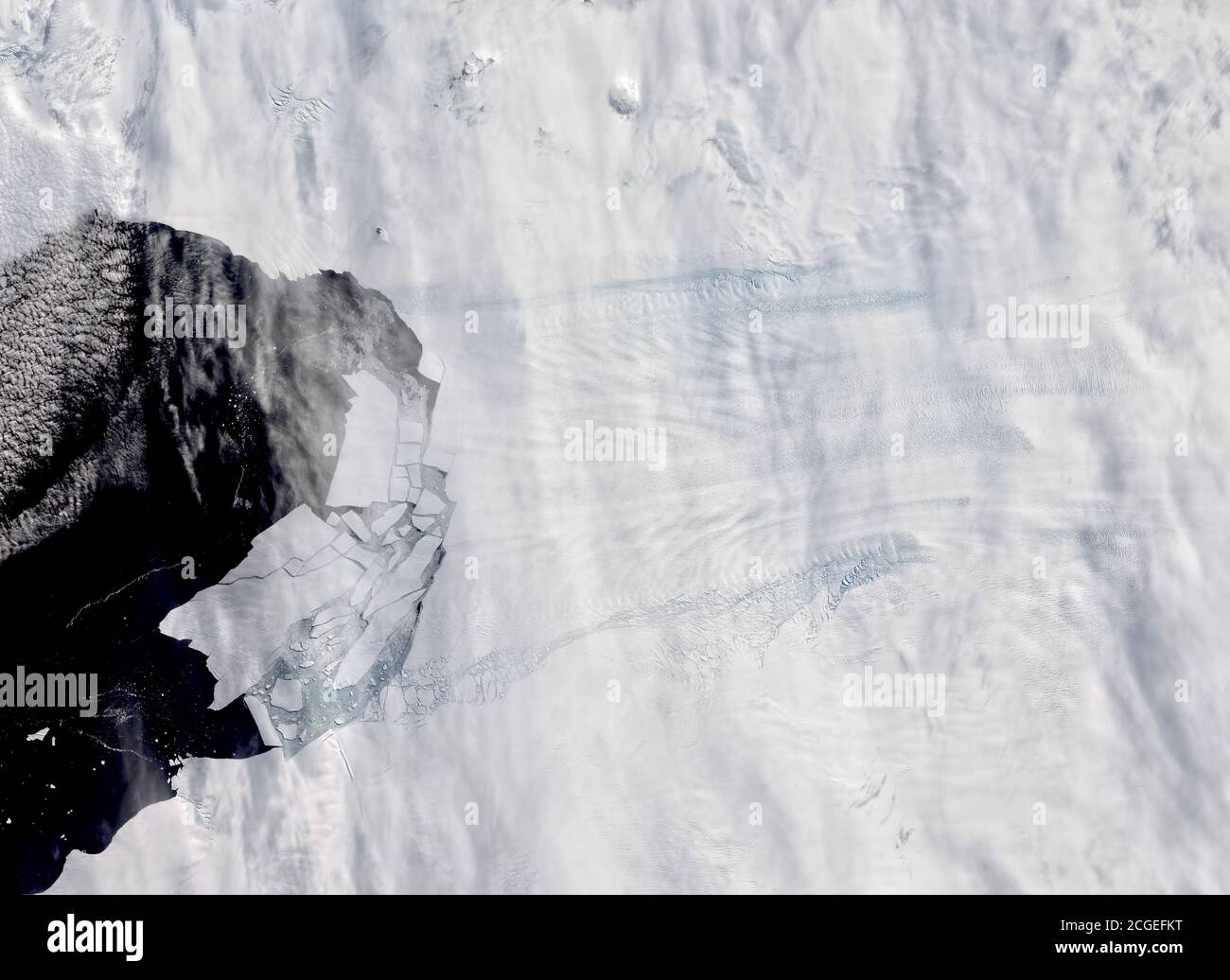 Antarctica’s Pine Island Glacier spawning new icebergs in Feb 2020. Th eimage shows the glacier and numerous icebergs detaching from the glacier and f Stock Photo