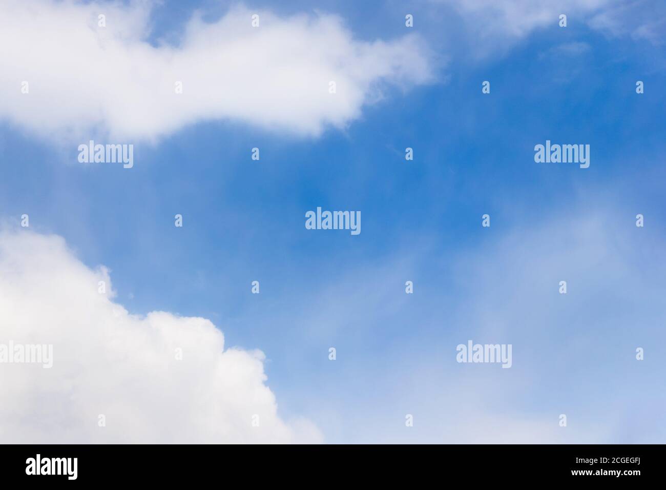 Beautiful white fluffy clouds on a blue sky background, copy space Stock Photo