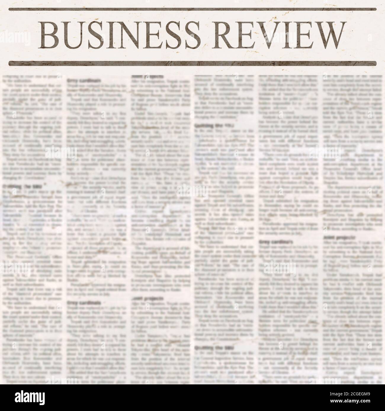Newspaper with headline Business Review and old unreadable text