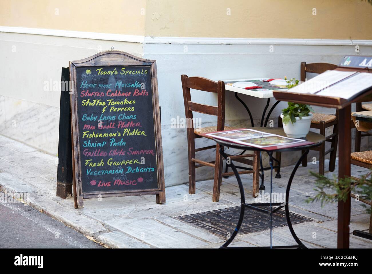 Taverna menu, chairs and table at Plaka Athens Greece Stock Photo