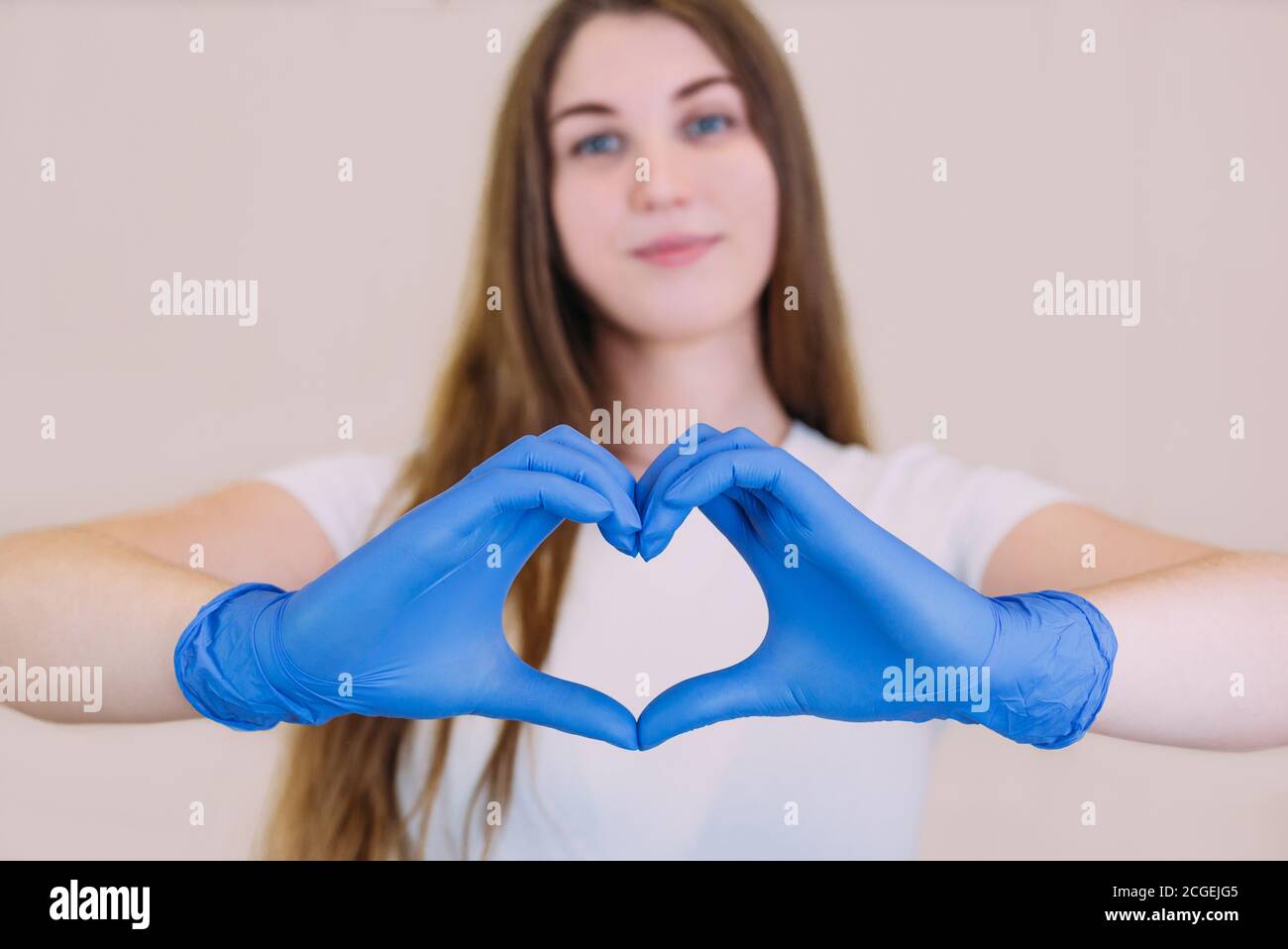young beautiful girl in a white tshirt in blue gloves holding hands in
