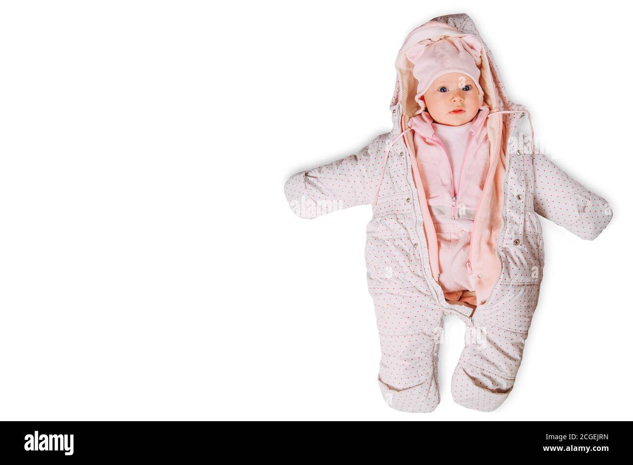 Infant child warmly dressed hat and warm suit with hood and hat lying on white izolated. Stock Photo
