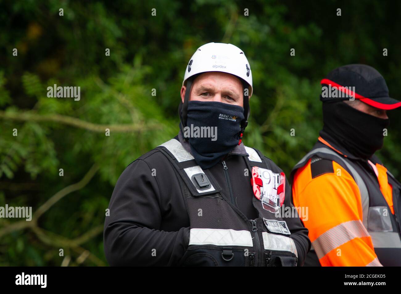 Denham, Buckinghamshire, UK. 8th September, 2020. A National Eviction Team Enforecement Agent and HS2 security guard near the camp. A young female tree protector scaled a tree this morning earmarked to be cut down by HS2. A new injuction barring environmental activists and tree protectors from land in the Denham Country Park has been granted to HS2. The controversial HS2 High Speed Rail link is set to damage or destroy 108 ancient woodlands. Credit: Maureen McLean/Alamy Stock Photo