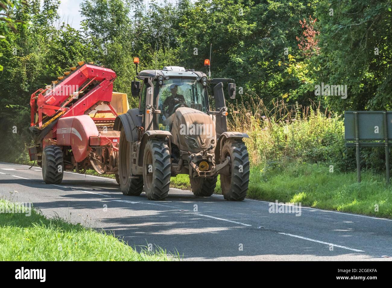 Folded and stowed Grimme potato harvester on road travelling between field locations. For UK potato growers, potato production, farm machinery. Stock Photo