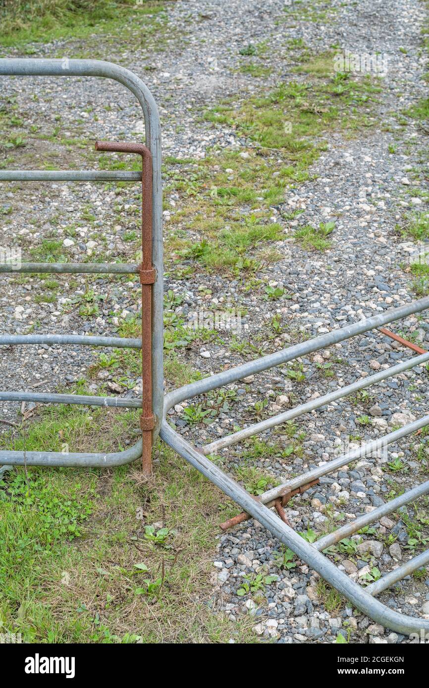 Collapsed galvanized steel farm gate. For falling profits in UK, farm incomes collapsing, falling incomes for farmers, commodity price falls. Stock Photo