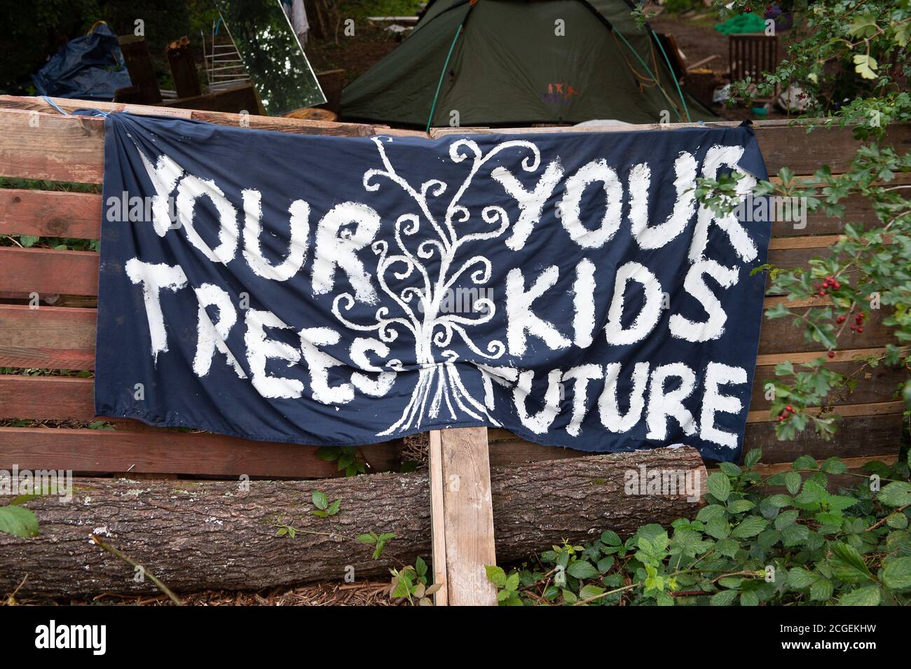 Denham, Buckinghamshire, UK. 8th September, 2020. A Your trees, your kids future, stop HS2 banner at the  camp entrance. A new injuction barring environmental activists and tree protectors from land in the Denham Country Park has been granted to HS2. The National Eviction Team and Police Liasion Officers were at the HS2 site today next to the HS2 Denham Protection Camp as a young female tree protector scaled one of the many trees to be felled by HS2. The controversial HS2 High Speed Rail link is set to damage or destroy 108 ancient woodlands. Credit: Maureen McLean/Alamy Stock Photo