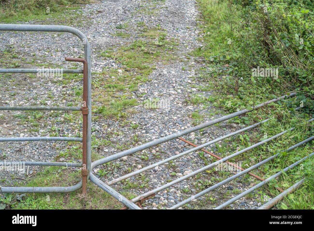 Collapsed galvanized steel farm gate. For falling profits in UK, farm incomes collapsing, falling incomes for farmers, commodity price falls. Stock Photo