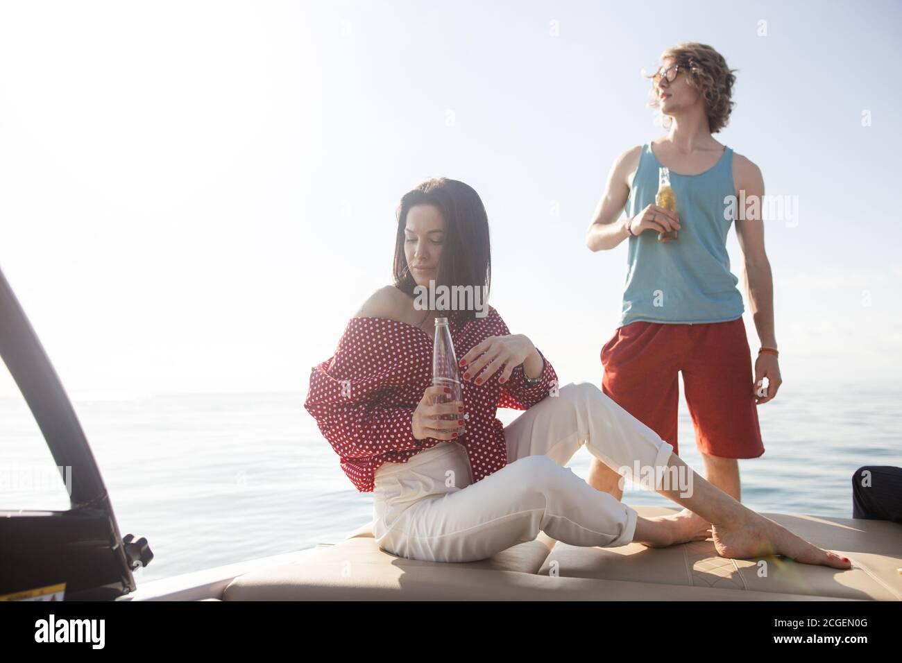 friends drinking beers in boat party. Group of people partying on yacht