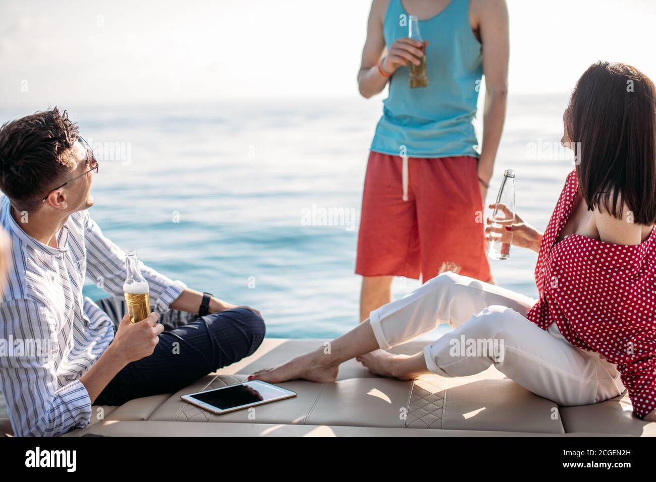 friends making boat party having fun drinking beers and laughing