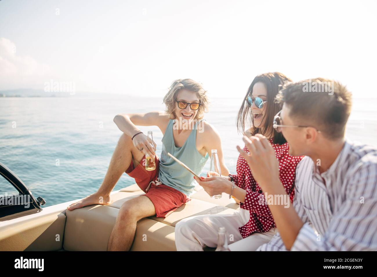 friends drinking beers in boat party. Group of people partying on yacht
