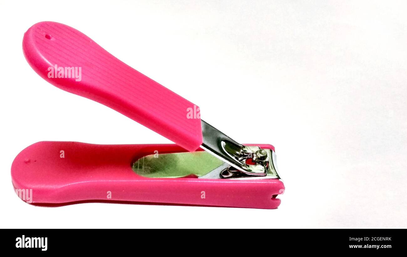 A pink nail clipper on white background Stock Photo