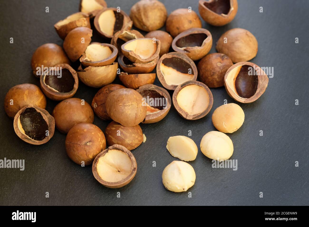 Macadamia nut shell on black background. Raw macadamia nuts and brown shells Stock Photo Alamy