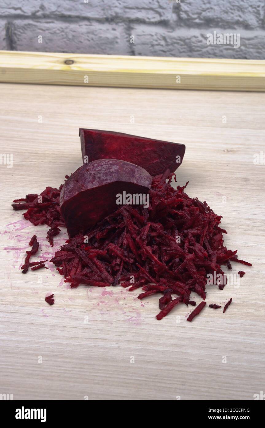 grate beetroot on a grater, fresh beet grated Stock Photo