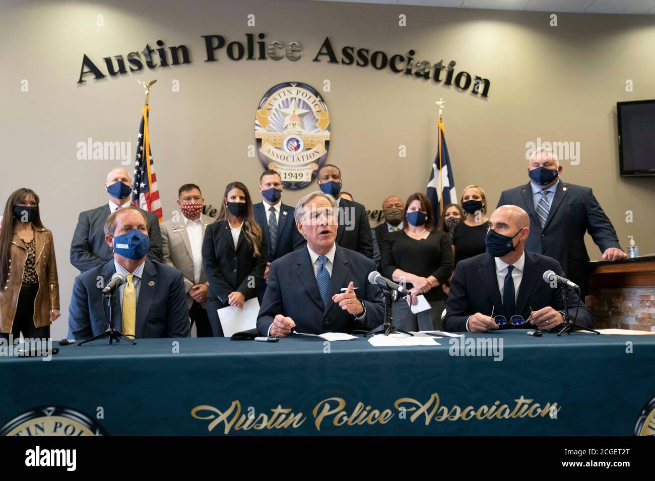 Austin, TX USA September 10, 2020: Texas Governor Greg Abbott, c, flanked by Republican Attorney General Ken Paxton, l, and House Speaker Dennis Bonnen, holds a press conference with Austin police association leaders to announce a plan to punish Texas cities that cut police spending. Abbott also asked state legislators and candidates for office to sign a pledge backing police with the hashtag #TexasBackstheBlue. Credit: Bob Daemmrich/Alamy Live News Stock Photo