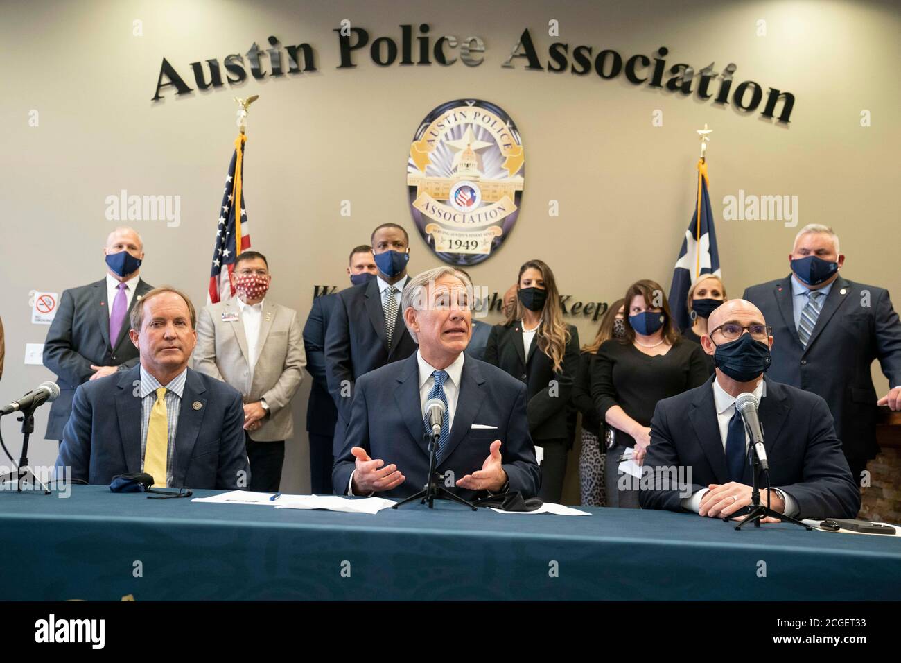 Austin, TX USA September 10, 2020: Texas Governor Greg Abbott, c, flanked by Republican Attorney General Ken Paxton, l, and House Speaker Dennis Bonnen, holds a press conference with Austin police association leaders to announce a plan to punish Texas cities that cut police spending. Abbott also asked state legislators and candidates for office to sign a pledge backing police with the hashtag #TexasBackstheBlue. Credit: Bob Daemmrich/Alamy Live News Stock Photo