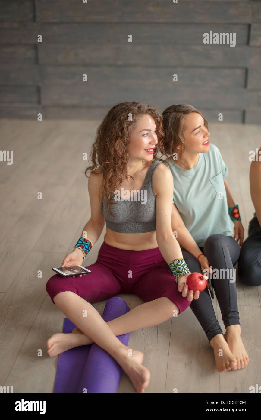 Cheerful fit young co-workers in sportswear having rest and drinking water  after workout on floor before going home. People, body shape, health, wellb  Stock Photo - Alamy