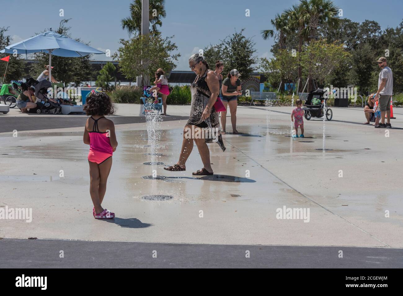Tourist enjoying the water sprinklers at St. Petersburg's new Pier district. St. Petersburg, Florida, USA Stock Photo