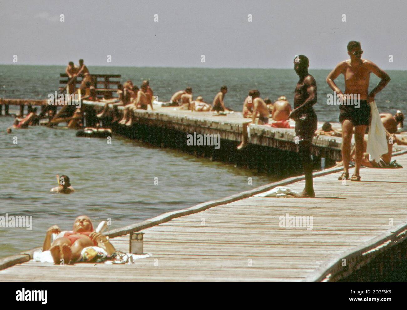 Tourists and Residents Enjoy the Southernmost Swimming Pier of the United States in Key West Florida ca. 1975 Stock Photo