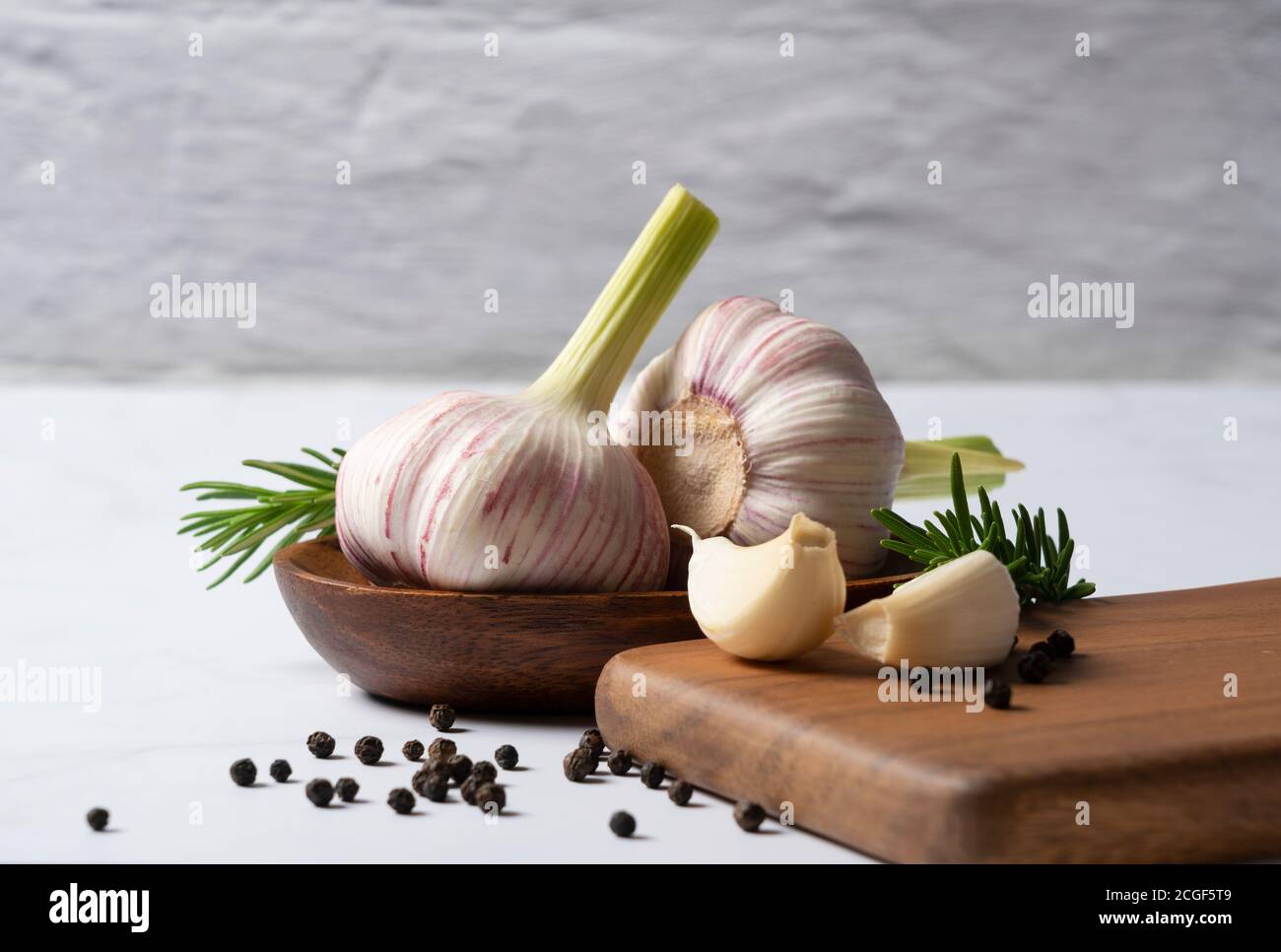 Fresh garlic, herbs and spices set on a marble table. Image of cooking ...