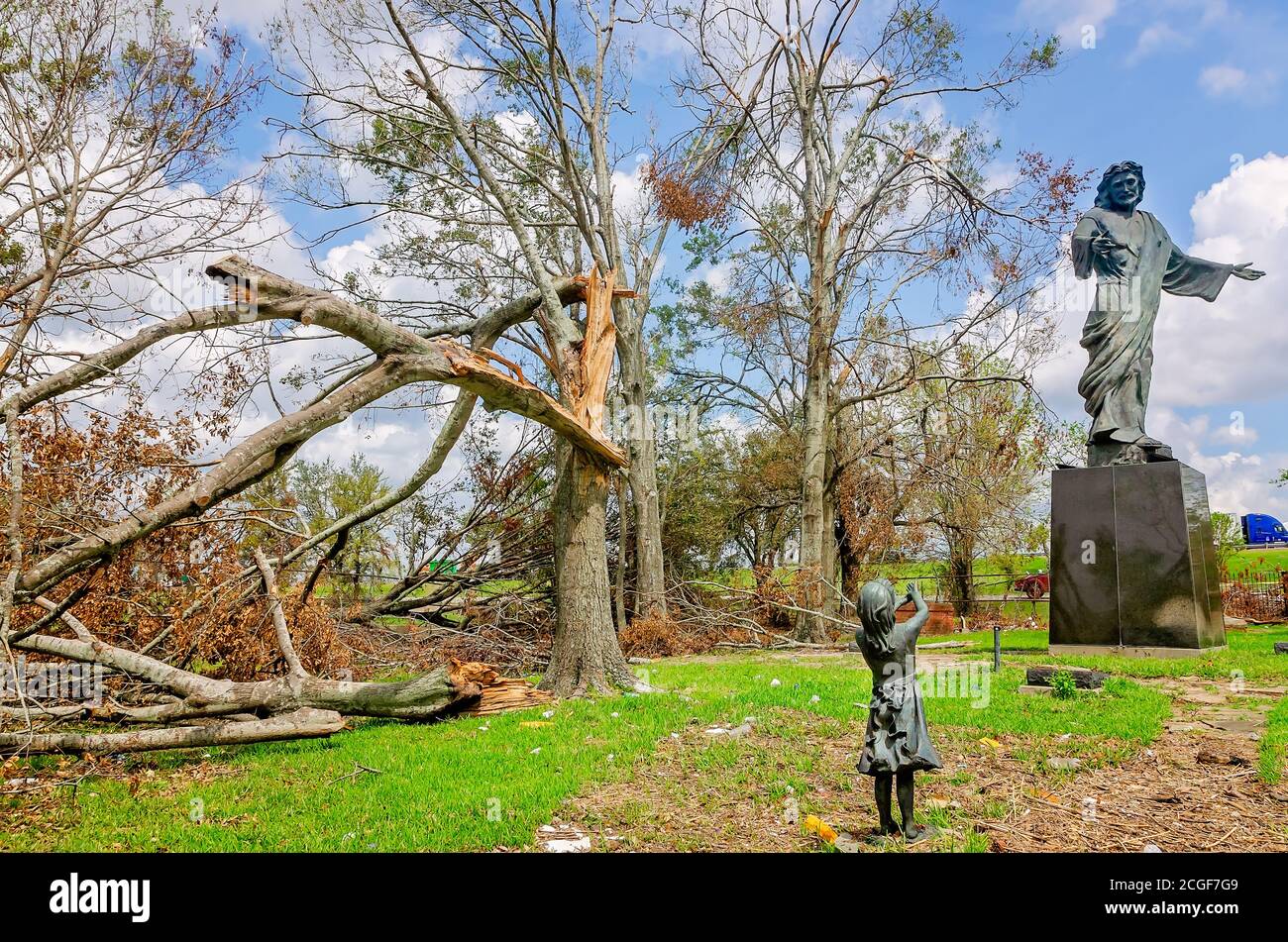 Fallen trees and debris from Hurricane Laura surrounds the Millennium Jesus statue at Bilbo Cemetery, Sept. 9, 2020, in Lake Charles, Louisiana. Stock Photo