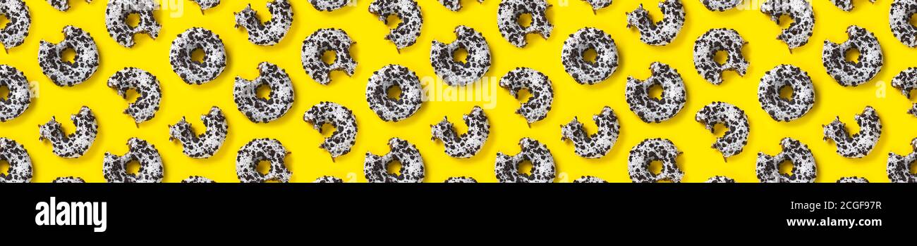 donuts on a yellow background top view. Flat lay of delicious nibbled ...
