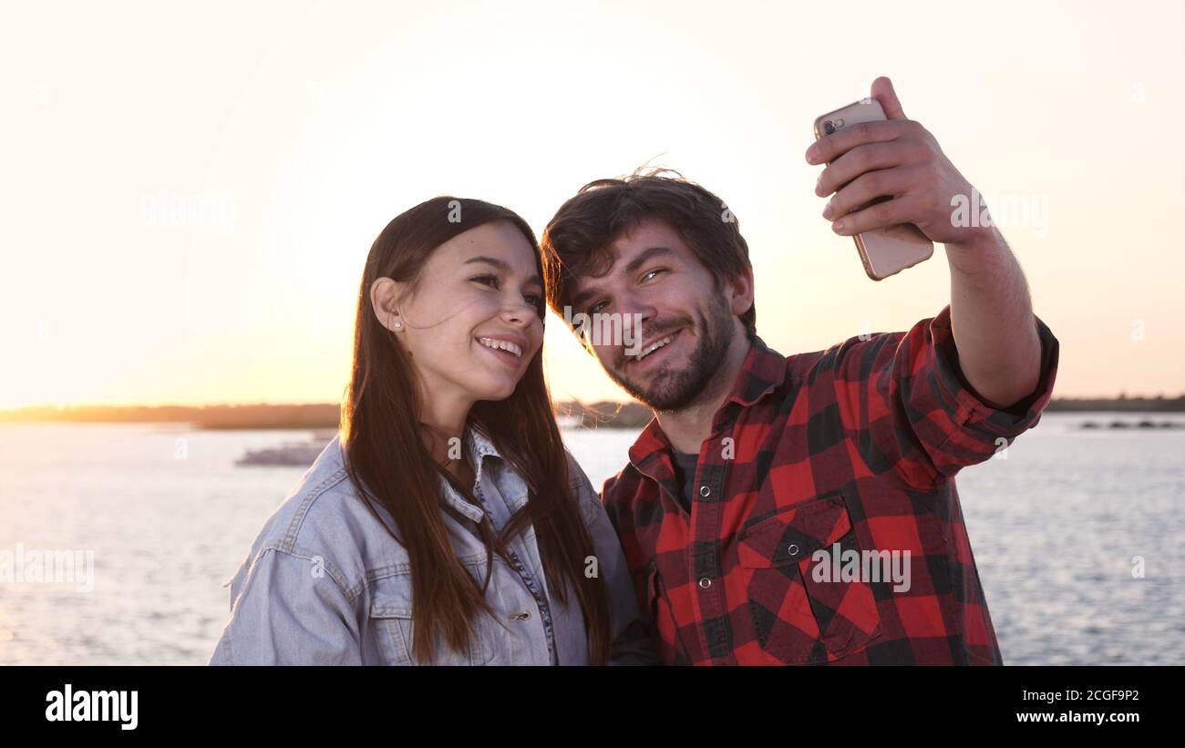 Couple in love taking selfies outdoors. Stock Photo