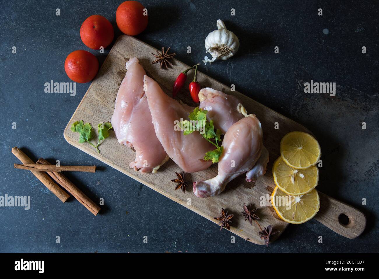 View from top of raw meat on a chopping board on a black background Stock Photo