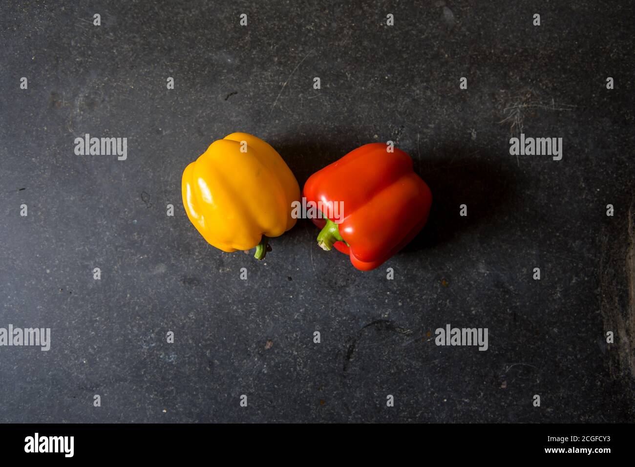 Top view of colorful bell peppers on a black background with use of selective focus. Stock Photo