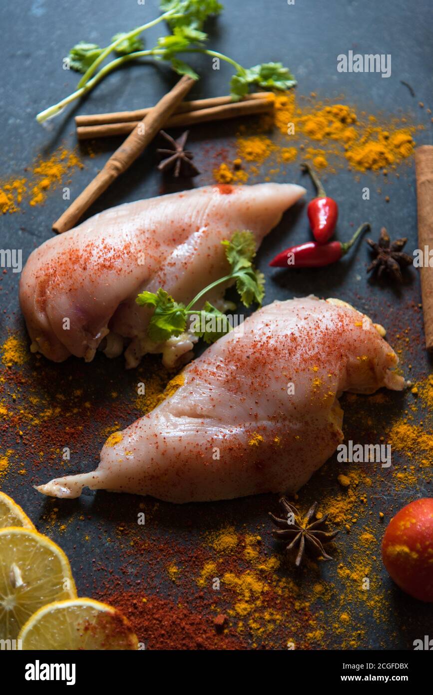 Raw chicken with vegetables and spices with a close up view. Stock Photo