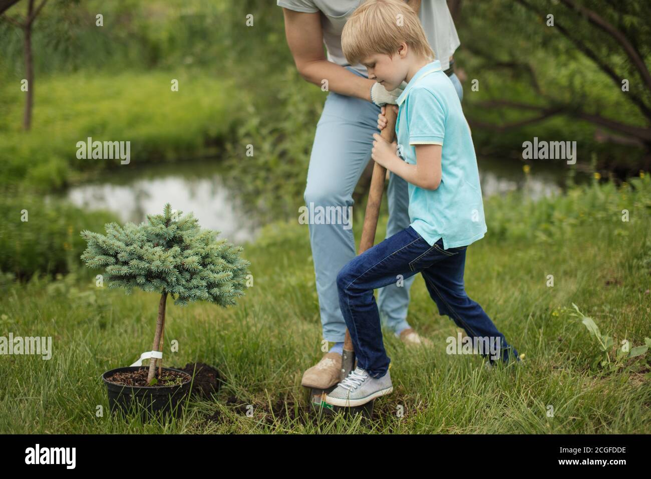 Fair haired little daddys helper son kid digging a whole together