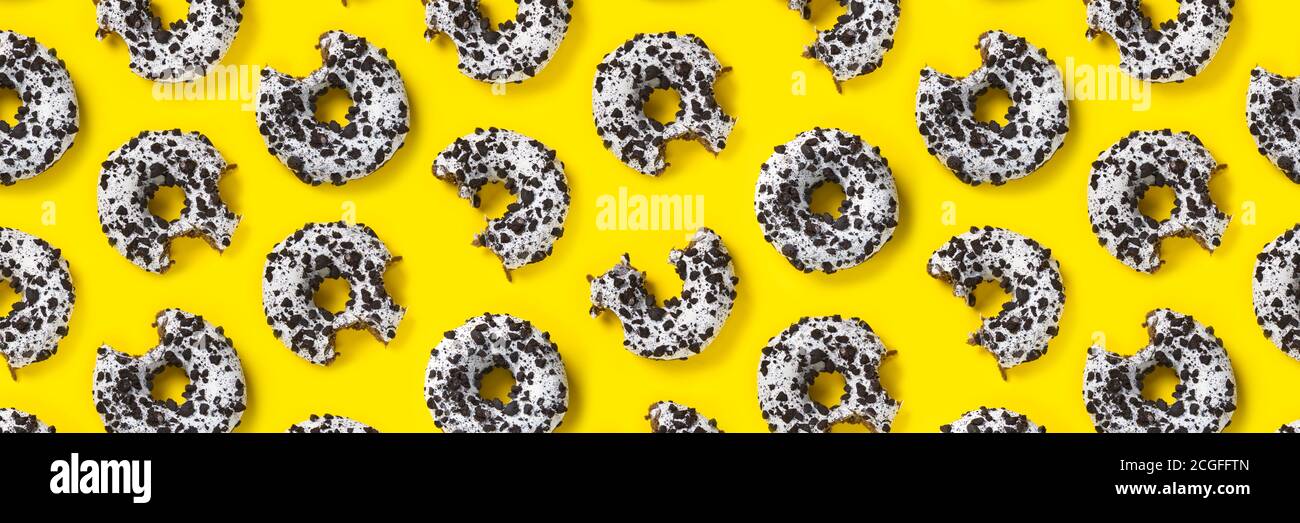 donuts on a yellow background top view. Flat lay of delicious nibbled ...