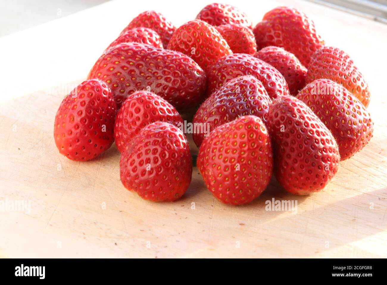 Group of people eating strawberries hi-res stock photography and images ...