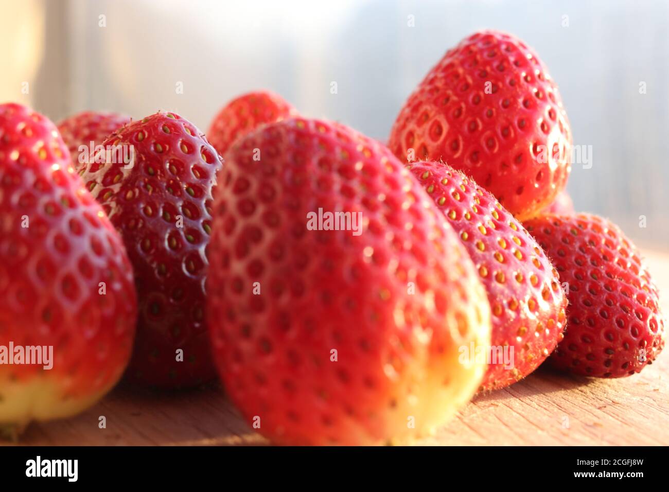 Group of people eating strawberries hi-res stock photography and images ...