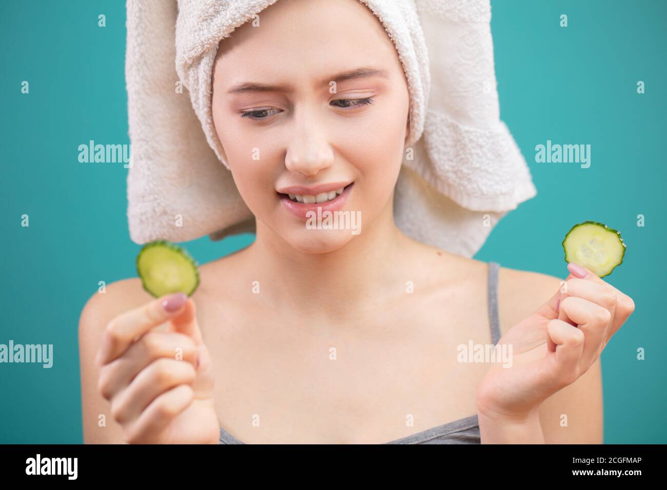 Cheerful beautiful woman with a towel wrapped around her head covering