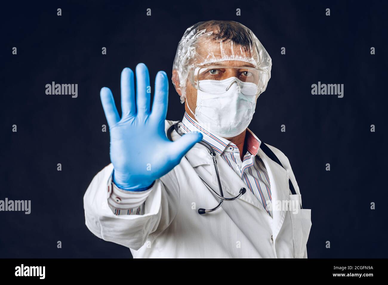 Male doctor showing stop sign, wearing medical mask and gloves Stock ...