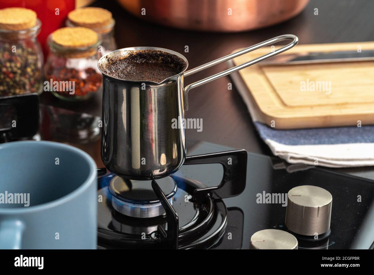 Brew coffee in a steel turk on a gas stove Stock Photo Alamy