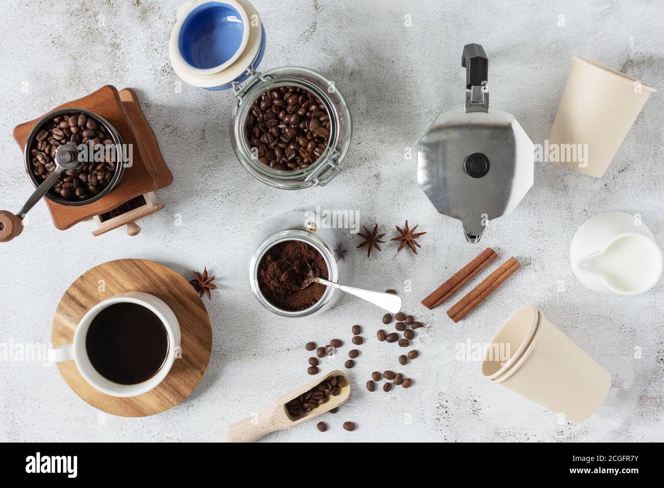 Ingredients and equipment for making coffee top view on grey background. Stock Photo