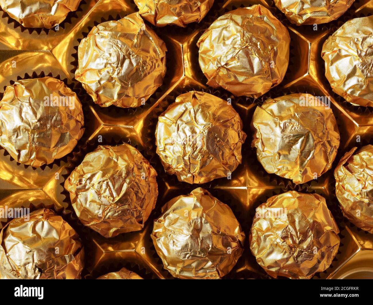 Chocolate candies in a gold wrapper, sweet chocolate candies. The view