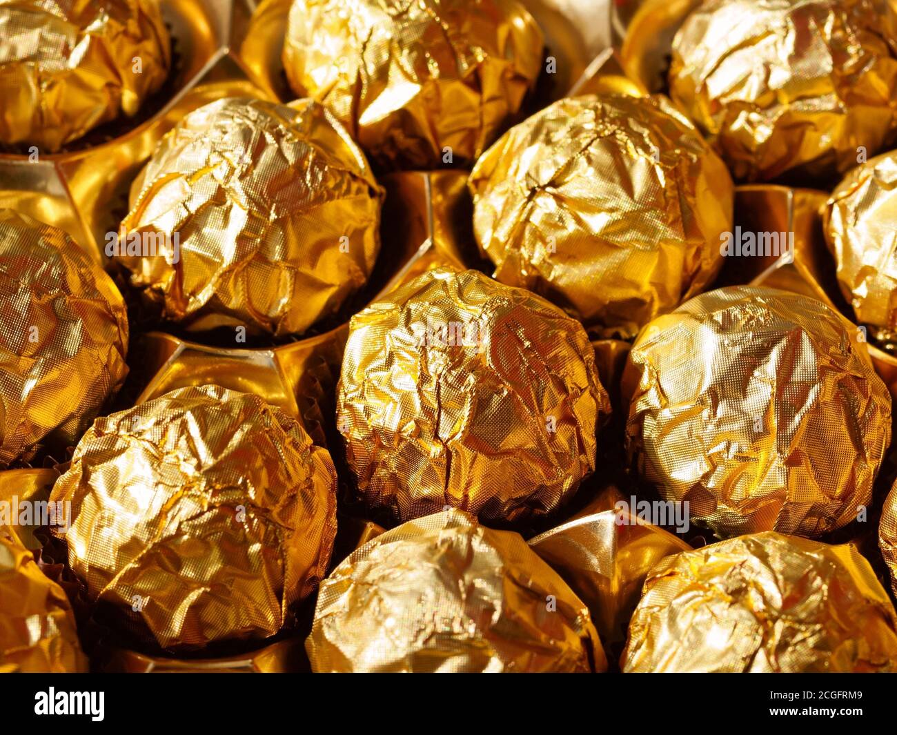 Chocolate candies in a gold wrapper, sweet chocolate candies. The view