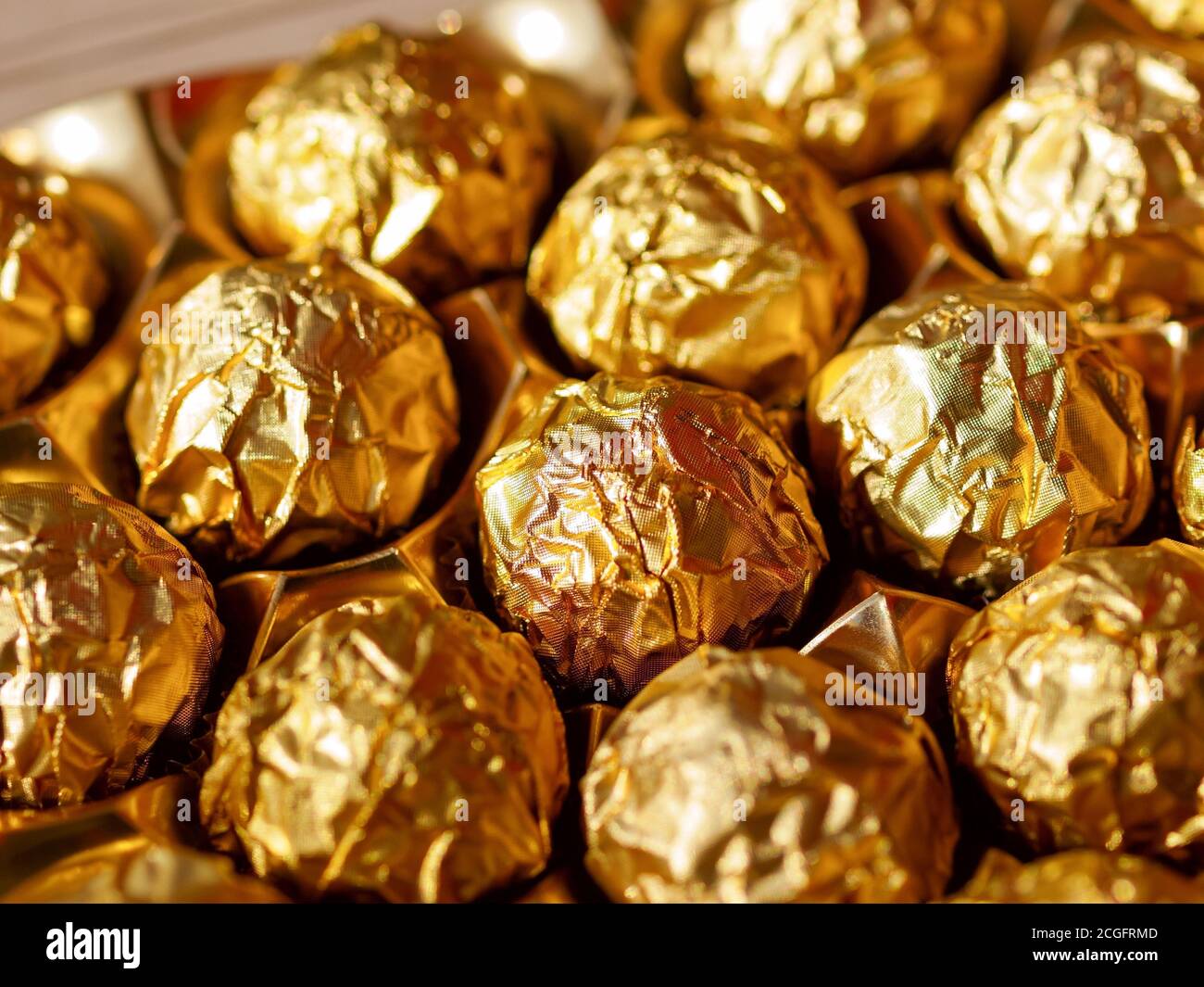 Chocolate candies in a gold wrapper, sweet chocolate candies Stock