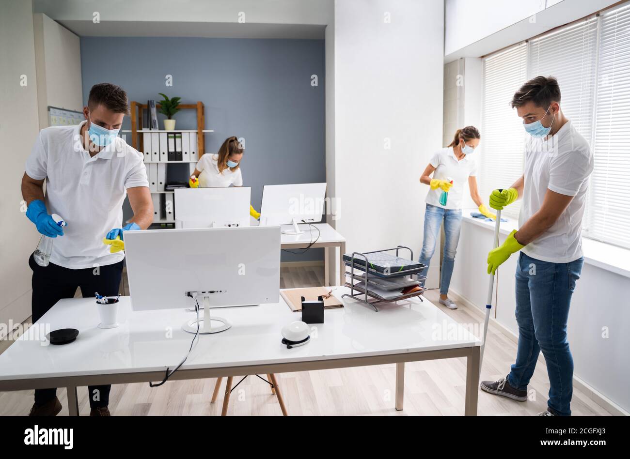 Professional Office Cleaning Services With Face Masks Stock Photo - Alamy