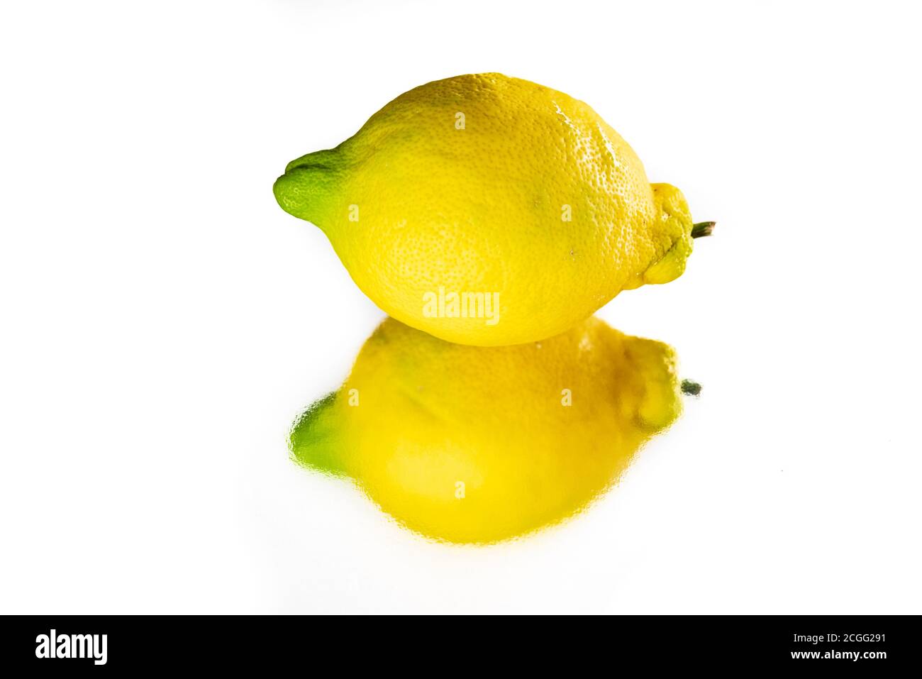 Whole lemon and reflection over white background Stock Photo