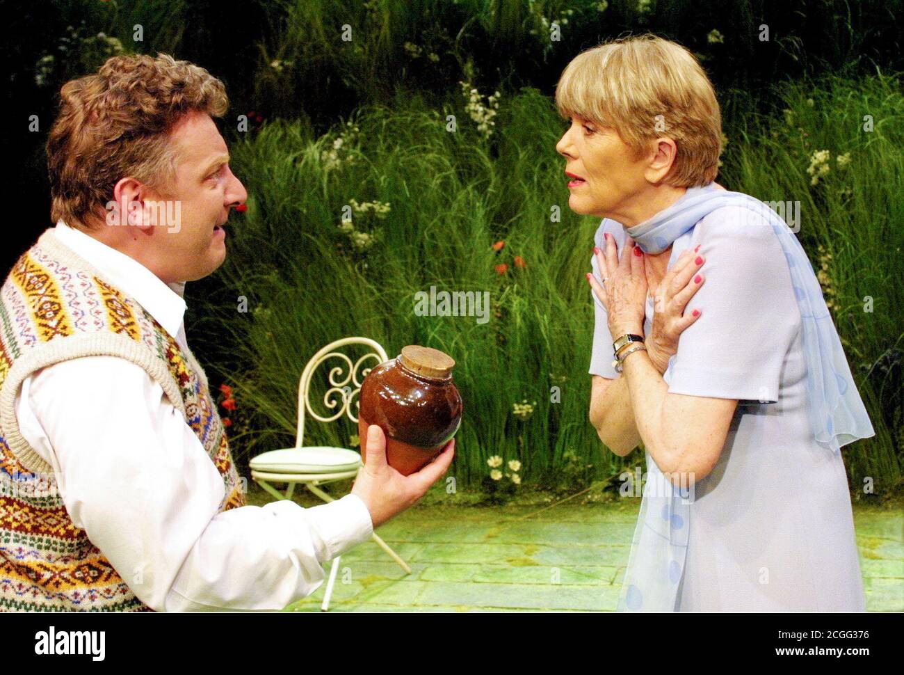 Simon Russell Beale (Felix Humble - holding the urn containing his father's ashes) with Diana Rigg (Flora Humble) in HUMBLE BOY by Charlotte Jones at the Cottesloe Theatre, National Theatre (NT), London SE1  09/08/2001  set design: Tim Hatley costumes: Lucy Roberts lighting: Paul Pyant director: John Caird Stock Photo