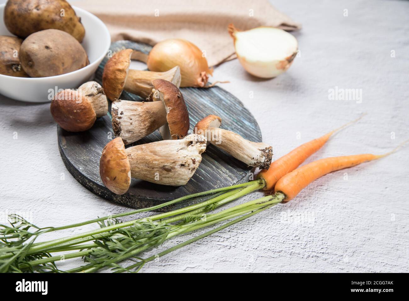 White forest mushrooms on a light background. Cooking organic mushrooms