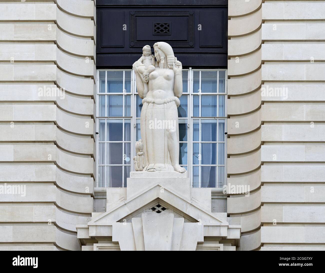 London, England, UK. Sculpture:'Child Education' by Alfred Hardiman, sculptor. 1921. Portland stone. on the West facade of County Hall on the South Ba Stock Photo