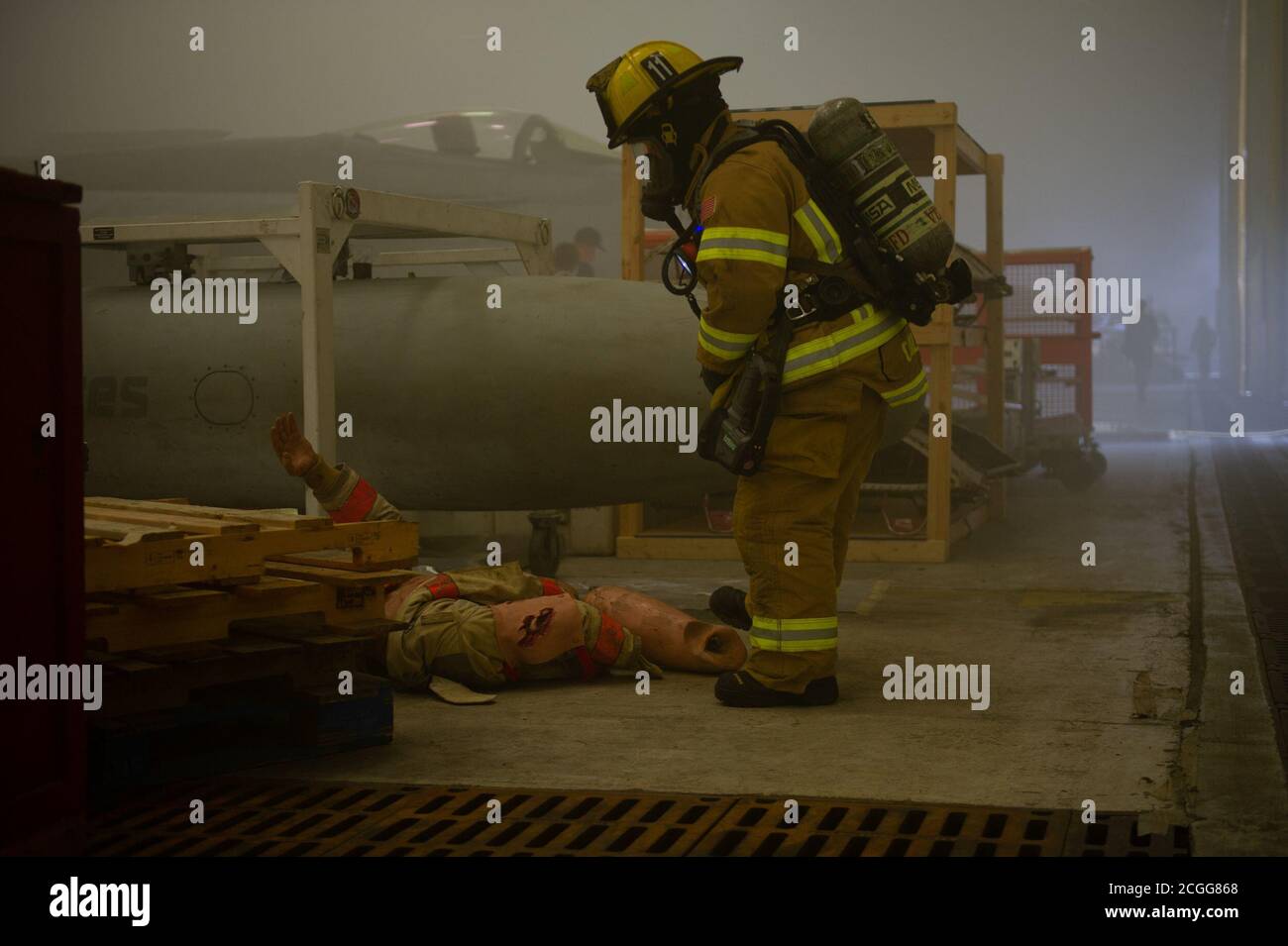 VIRGINIA BEACH, Va. (Sept. 9, 2020) A firefighter assigned to Navy Region Mid-Atlantic Fire & Emergency Services prepares to tend to a simulated casualty during an emergency training exercise inside a hangar on board Naval Air Station Oceana. The goal of the exercise was to enhance the readiness of response teams and maintain interoperability between Navy leadership and the City of Virginia Beach. (U.S. Navy photo by Aviation Ordnanceman 2nd Class Benjamin Perrigo/Released) Stock Photo